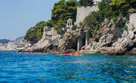 Adriatic Sea near Dubrovnik, Croatia - August 13 2021: people on kayaking boats near the coastのeditorial素材