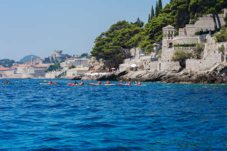 Adriatic Sea near Dubrovnik, Croatia - August 13 2021: people on kayaking boats near the coastのeditorial素材