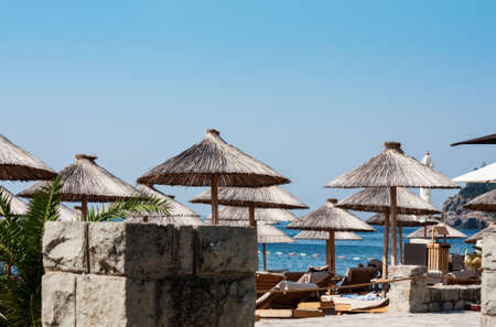beach hut with umbrellas near Old Town Budva in Montenegro, Europe, Adriatic Sea and mountains,の写真素材