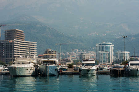 city port with pleasure boats, fishing boats and yachts near the old town of Budva, Montenegro, Adriatic seaの写真素材