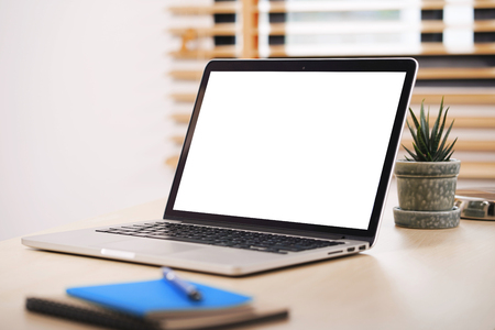 Conceptual workspace, Laptop computer with blank white screen on table.の写真素材