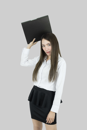 Angry asian business woman with folder having stress.の写真素材