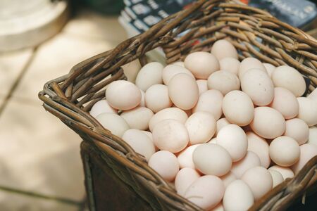 Fresh duck eggs in basket.
