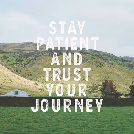 Inspirational motivational quote "stay patient and trust your journey." with mountain view background.の写真素材