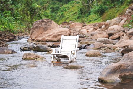 White wooden beach chair in the river.の写真素材