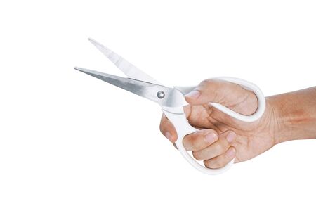 Hand is holding white scissors isolated on white background.の写真素材