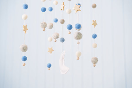 Baby crib mobile. Toys above the baby crib. Hanging soft balls for the child.の写真素材