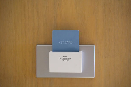 Electronic lock with key card inserted. Key card into hotel room door lock.