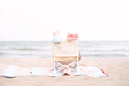 Baby sitting on the beach in beautiful summer day.の写真素材