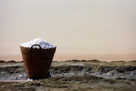 salt in the bamboo basket on the ground near salt pan, Thailandの写真素材