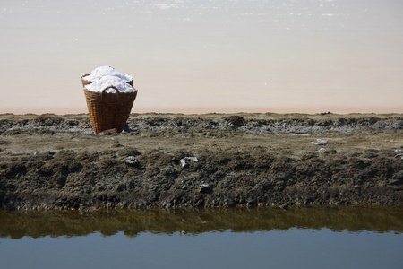 salt in the bamboo basket on the ground near salt pan, Thailandの写真素材