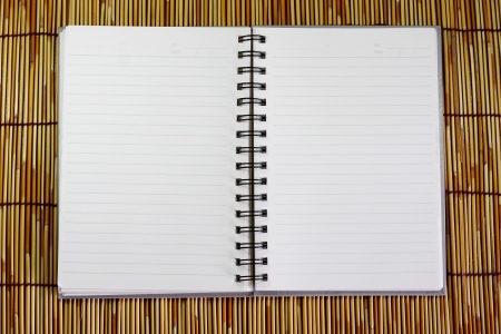 Notebook on bamboo background.の写真素材