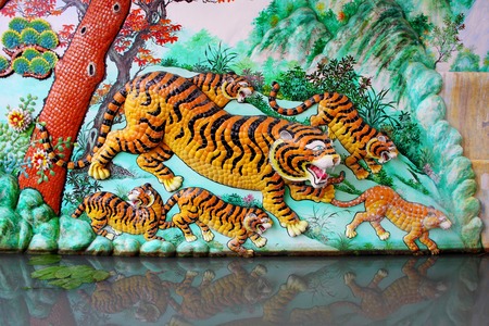 Bas Relief (tigers) in Naja Shrine, Chinese temple at Angsila, Chonburi, Thailand.の写真素材