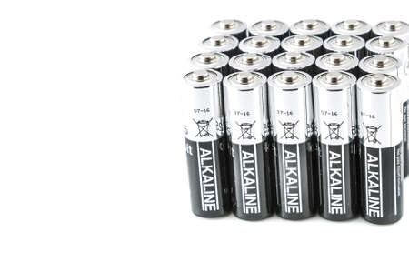 Silver and black batteries aligned and isolated on a white background