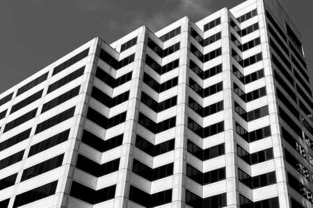 A low angle closeup greyscale of a buildingの写真素材