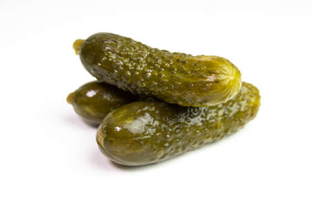 Three pickled cucumbers isolated on white. Crunchy pickles / gherkinsの写真素材