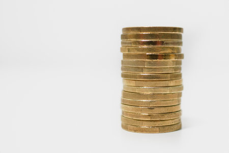 Stack of Euro coins on white background, side view with copy space to the left. Saving money.の写真素材