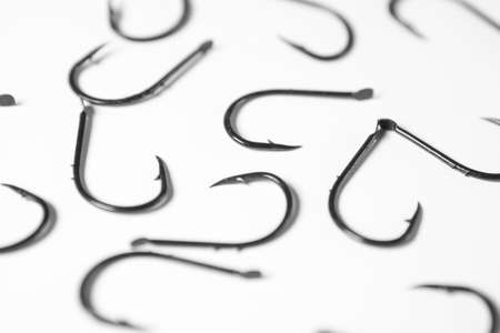 Group of fishing hooks on white background, shallow depth of field.の写真素材