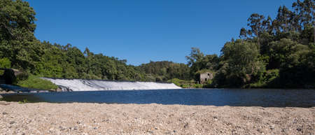 Beautiful Portuguese landscape. River Ave in Portugal on a bright sunny day in summer.の写真素材