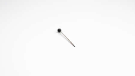 Sewing pin on white background. Selective focus with only the point in sharp focus.の写真素材