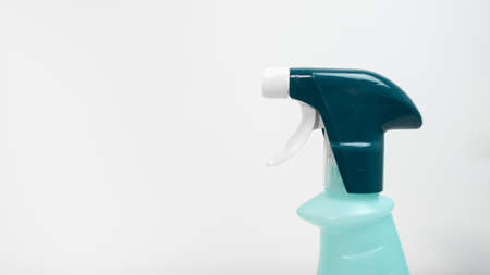 Disinfectant spray bottle on white background. Close up on nozzle, copy space on left.の写真素材