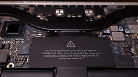 Warning label on Apple Macbook Pro motherboard. Only authorized repair providers.のeditorial素材