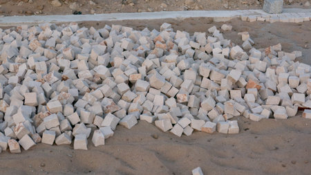 Stones in sand for construction of traditional Portuguese sidewalk pavement in Portugal.
