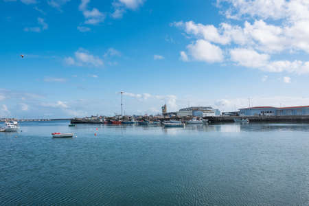 Fishing harbour in Povoa de Varzim, Portugal with boats. Bright sunny day with blue skyの写真素材