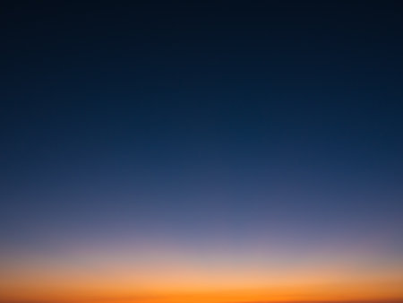 Beautiful gradient cloudless sky at dusk, from dark blue to orange