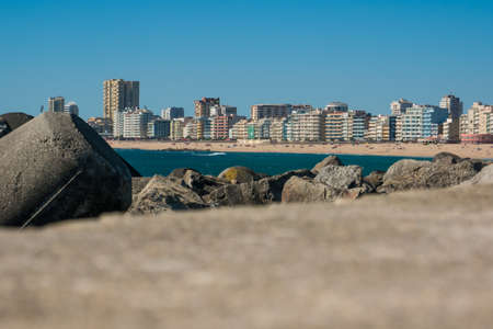 Beach and city of Povoa de Varzim in Portugal. Low angle. Harbor in foreground.の写真素材