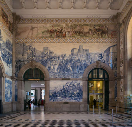 Sao Bento train station in Porto, Portugal. Interior with beautiful blue tiles on the wall depicting historic scenesのeditorial素材