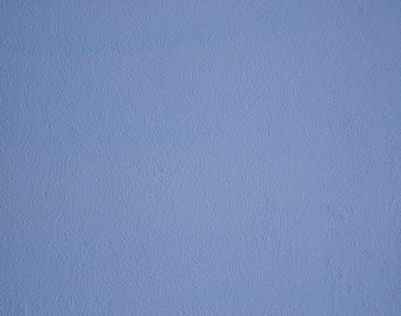 Rough light blue painted wall, stucco background texture.の写真素材