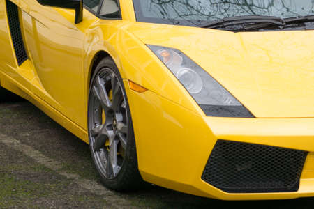 Wheel and headlight of a yellow Lamborghini car in London, England.のeditorial素材