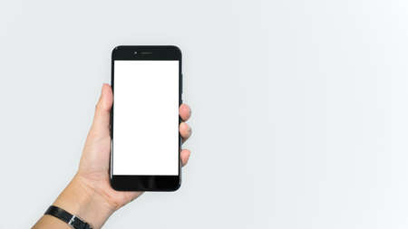 Male hand holding smart phone with white screenの写真素材