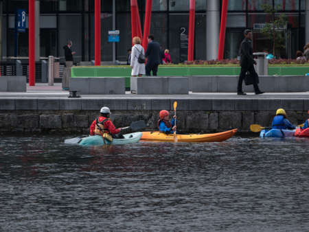 People in kayaks, rowing, Grand Canal Dock, Dublin, Ireland.のeditorial素材