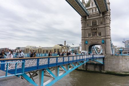People walking over Tower Bridge in London, UK