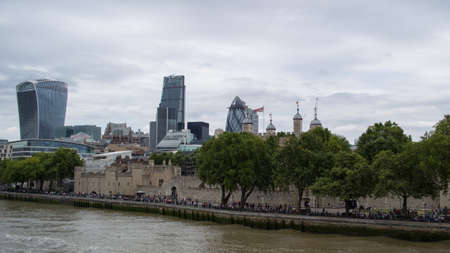 London, England cityscape with Tower of London in foreground and the modern square mile buildings in...
