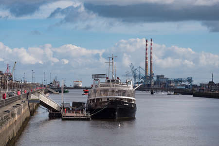 River Liffey in Dublin, Ireland. Dublin Port and the Docklands.  The restaurant Ship Cill Airne and the twin Poolbeg chimneysのeditorial素材