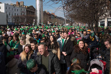 Crowds of people in green celebrate St. Patrick's day in Dublin, Irelandのeditorial素材