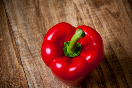 Fresh red pepper on wooden background