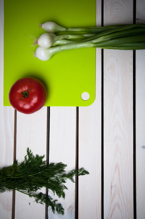 Tomatoes, onions, dill on a wooden vintage backgroundの写真素材