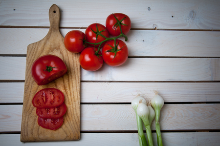 Tomatoes and onions on a wooden vintage backgroundの写真素材