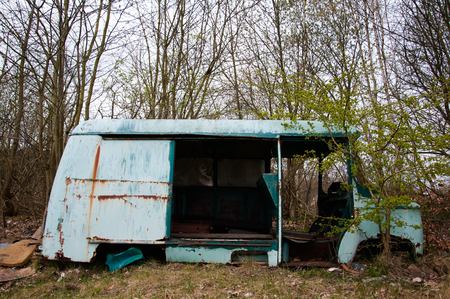 Old destroyed car at the edge of the forestの写真素材