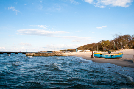 sandy beach shore with fishing boatの写真素材