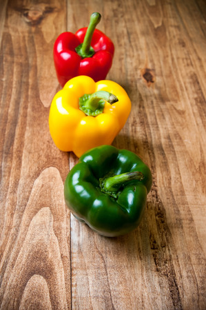 Red, yellow and green pepper on a tableの写真素材