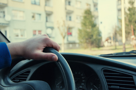 Driver's hand on a steering wheelの写真素材