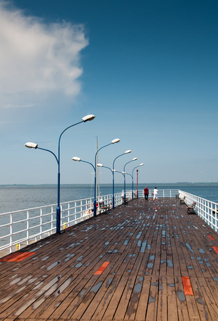 Wooden pier and lanterns on sunny summer dayの写真素材