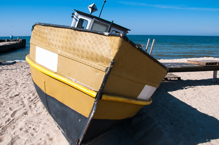 Old fishing boat moored on the beachの写真素材