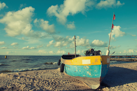 Old fishing boat moored on the beachの写真素材