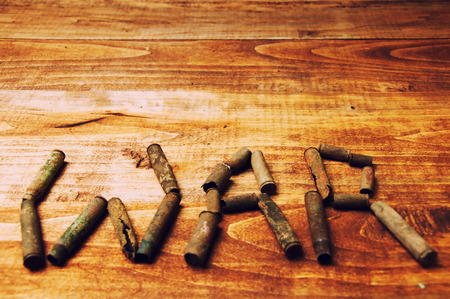 WAR made with cartridge shells on wooden tableの写真素材